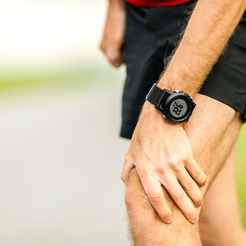 Knee pain, runner leg and muscle pain running and training outdoors, sport and jogging physical injuries when working out. Male athlete holding painful leg.
